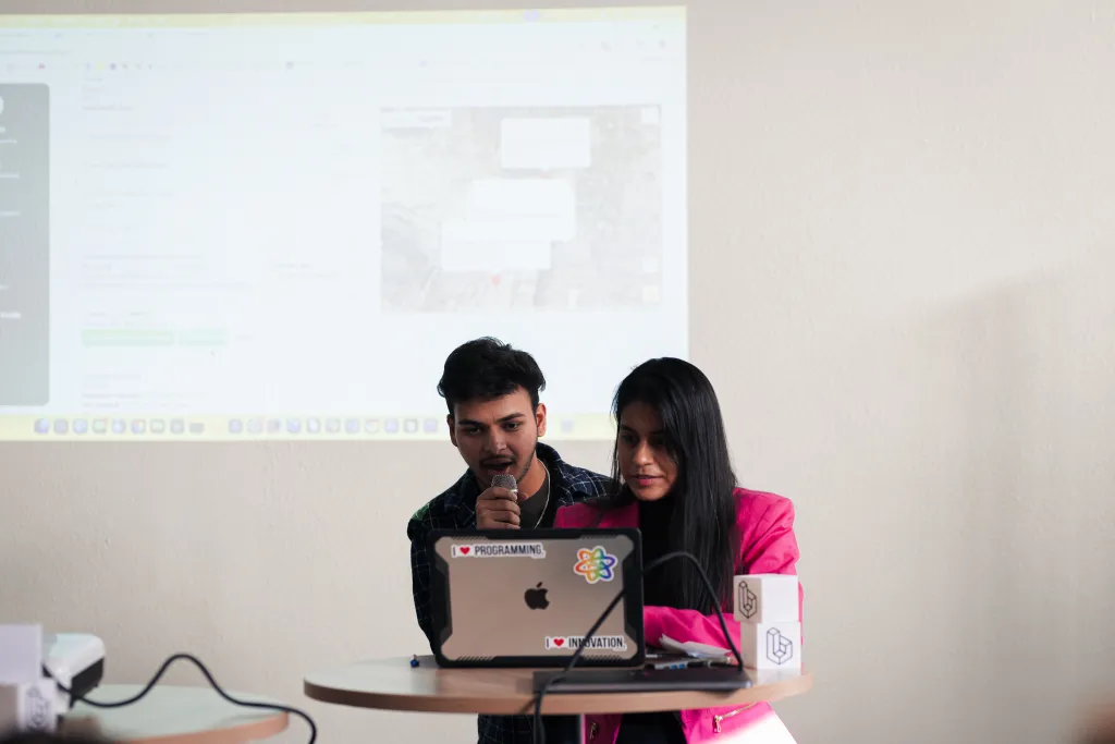 Team pitching their project on a laptop at Desert Dev Lab 2025