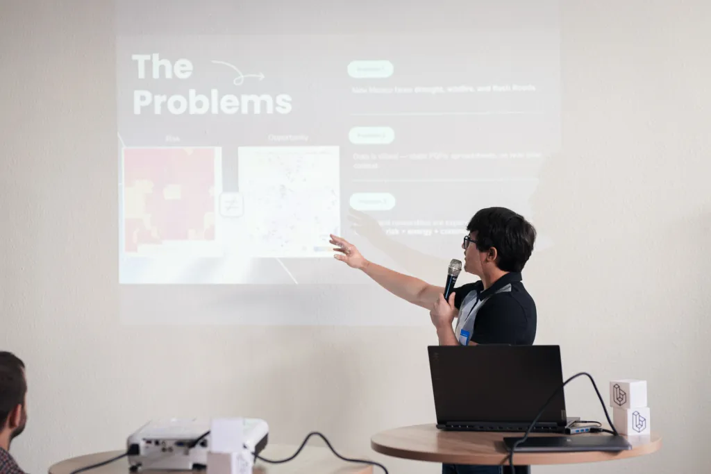 Presenter walking through 'The Problems' slide at Desert Dev Lab 2025