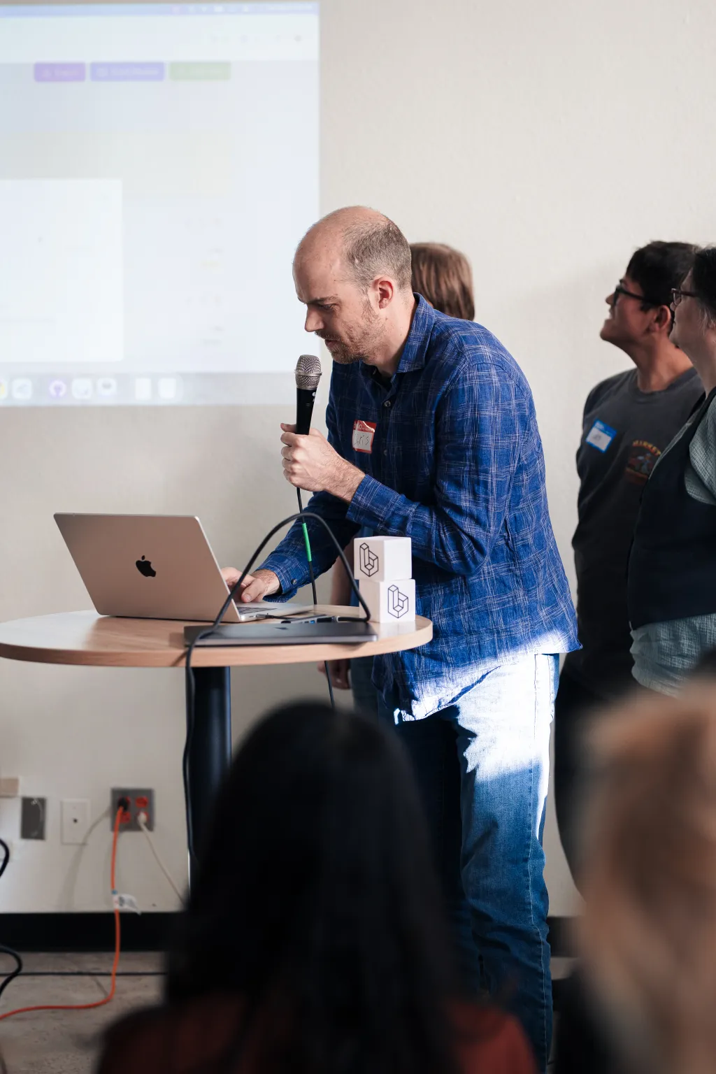 Presenter speaking with microphone at Desert Dev Lab 2025