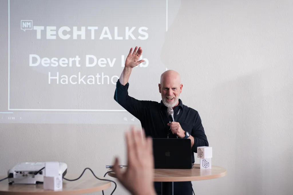 Organizer welcoming the room to Desert Dev Lab Hackathon 2025