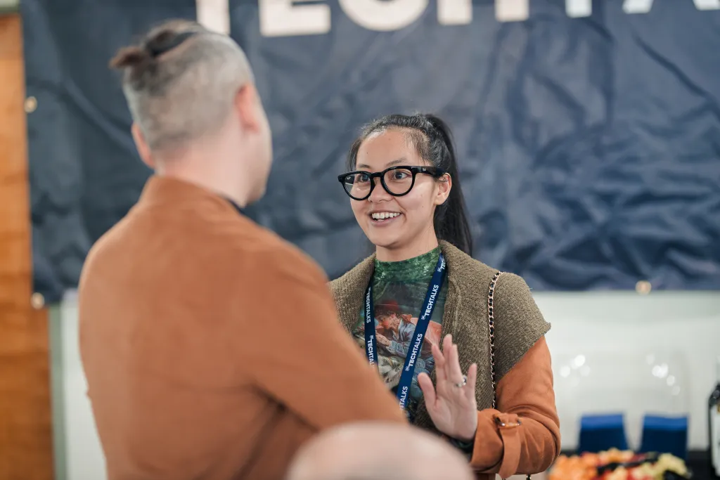 Attendees networking near the builders vc banner at Desert Dev Lab 2025