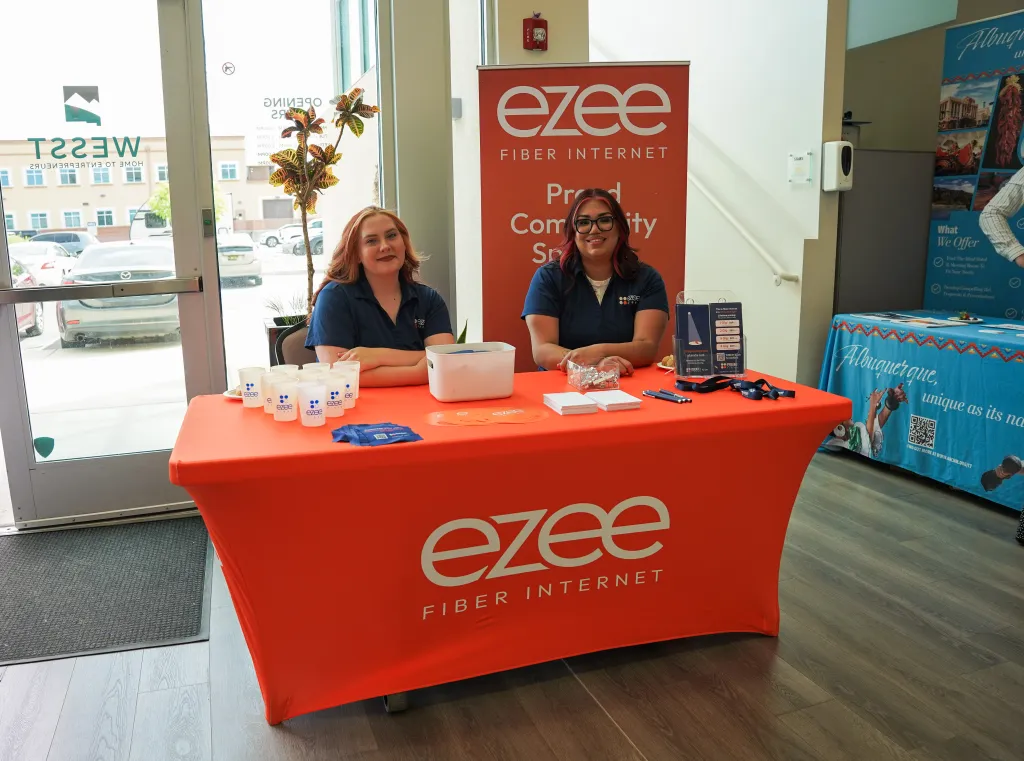 Ezee Fiber Internet booth staffed by two volunteers at Desert Dev Lab 2026