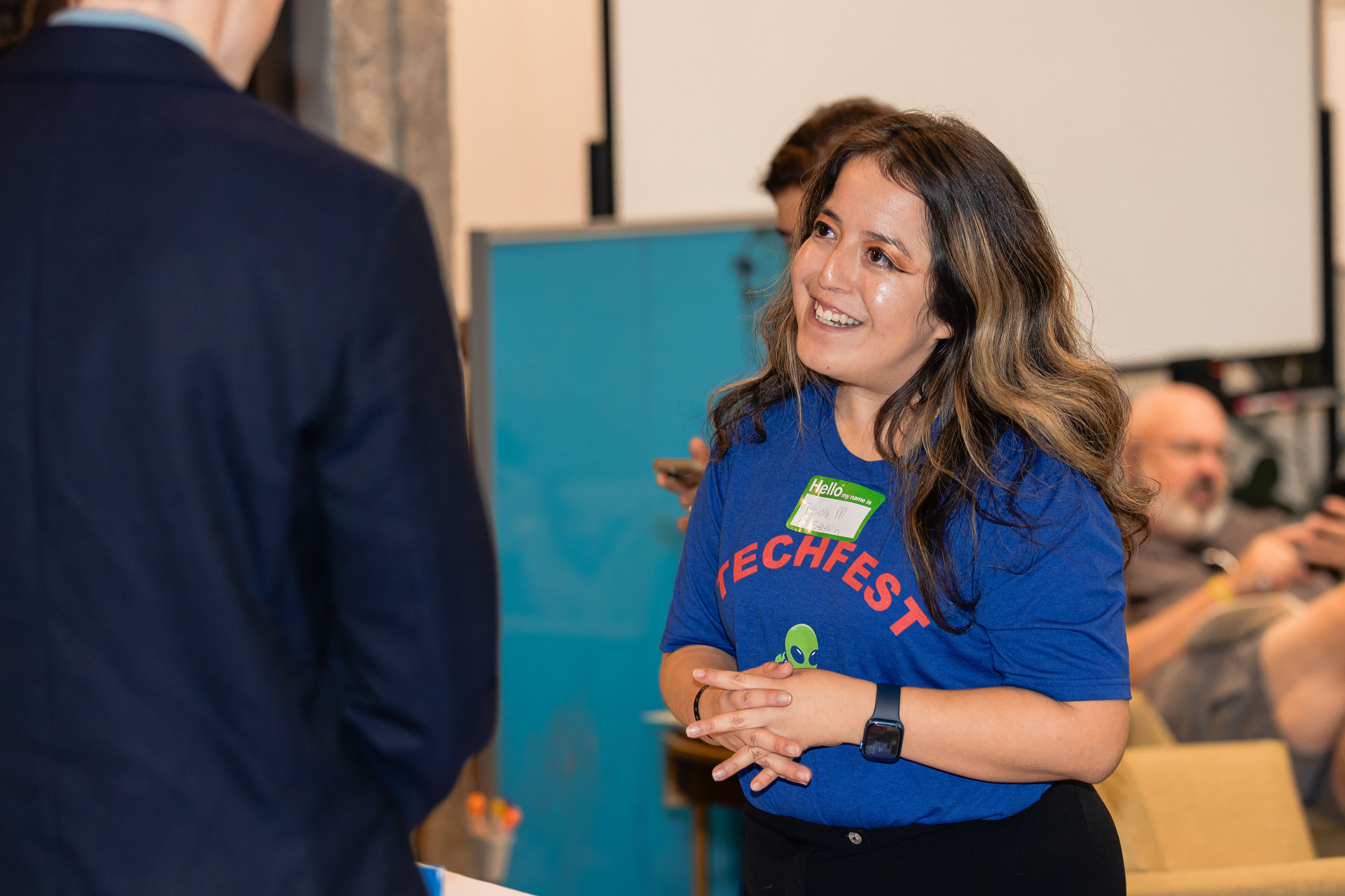TechFest volunteer staff member helping attendees